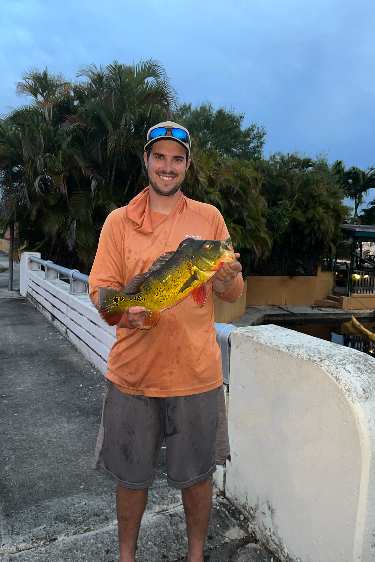 Picture of me with a peacock bass on a bridge. 