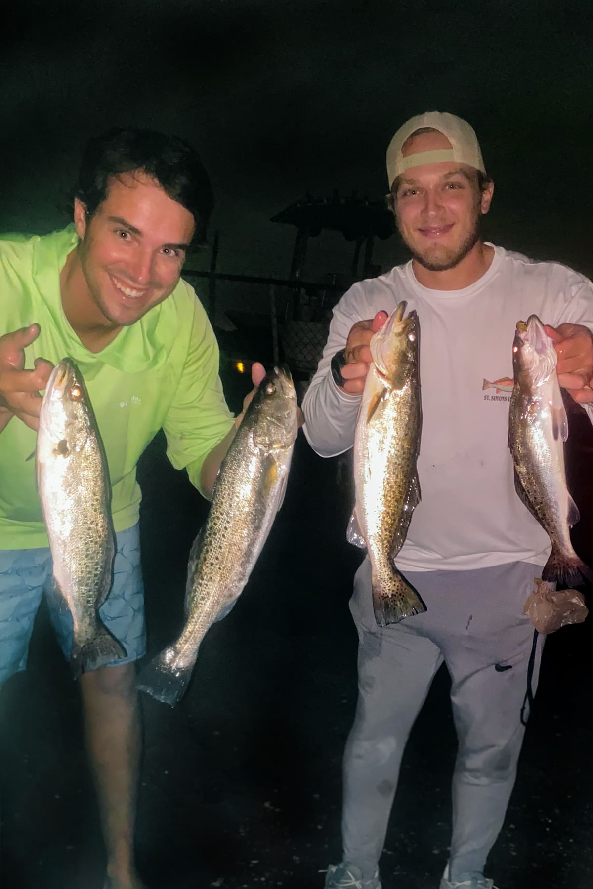 Me and my friend holding up four speckled sea trout.