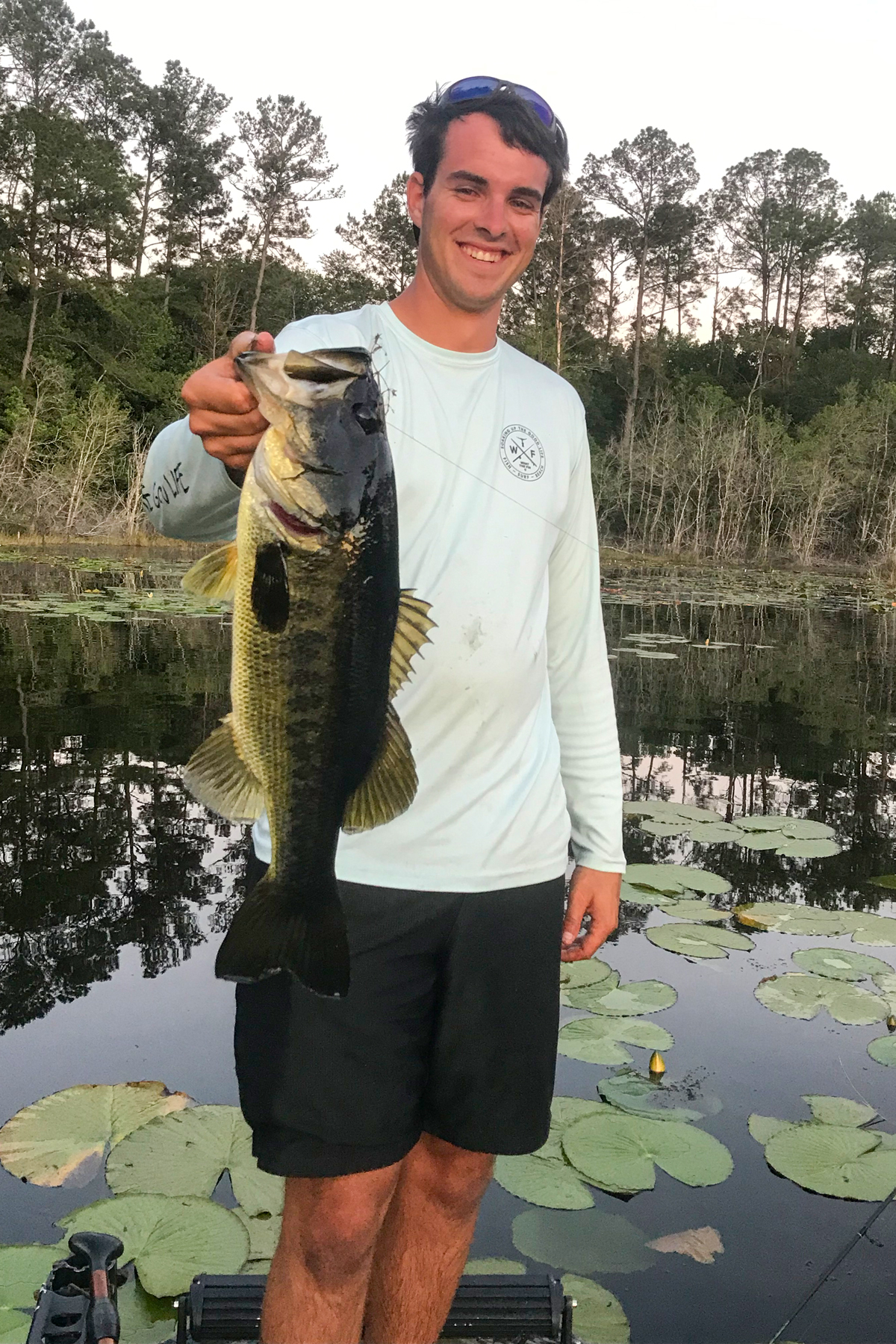 Me holding a largemouth bass on a lake. 