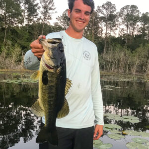 Me holding a largemouth bass on a pond.