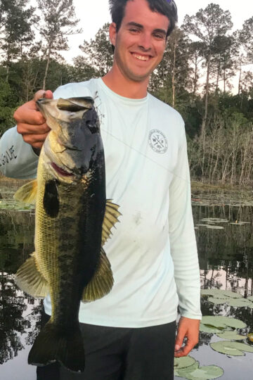 Me holding a largemouth bass on a pond.